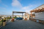 Outdoor community BBQ area with fireplace and bay views
